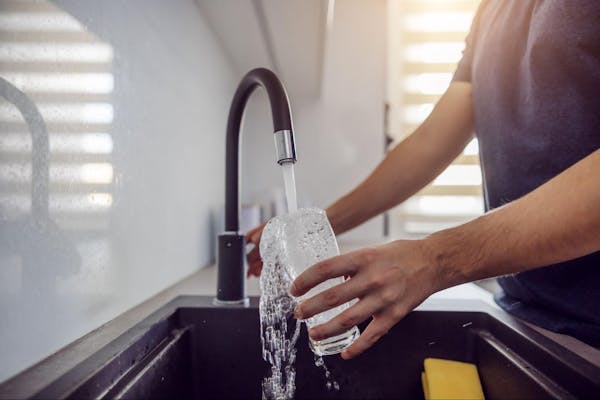 Man Drinking Water from Water Filter