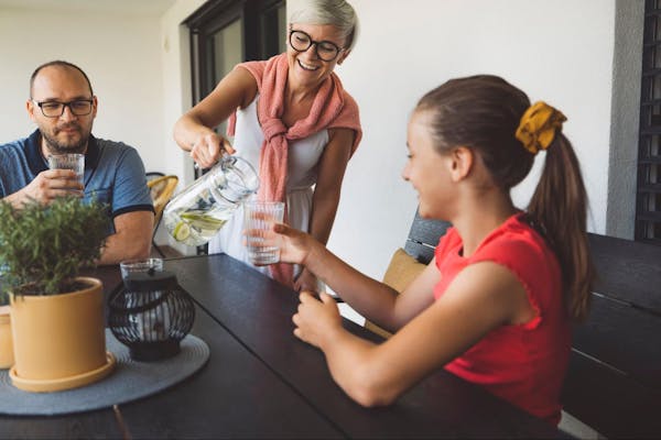 Family Drinking from Filtered Water Pitcher