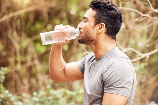 Guy Drinking ArtesIan Water from Bottle