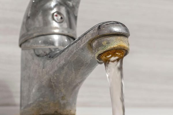 Image of Bad Aged Faucet Pouring Water