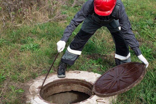 Workers Checks Water Quality per Manhole
