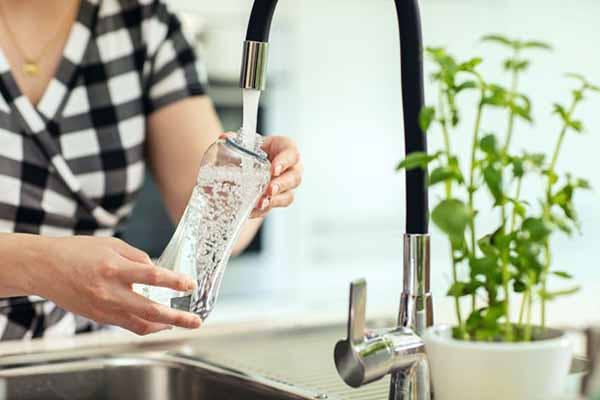 Reusable Water Bottle Photo of Woman Pouring in Fresh Water