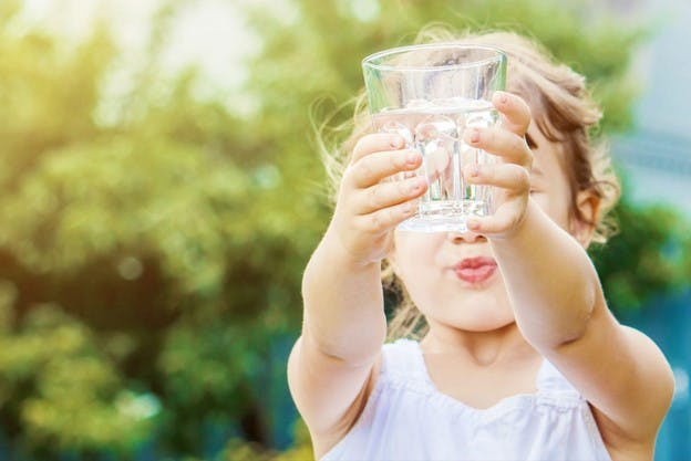 Child Holds Glass of Tap Water