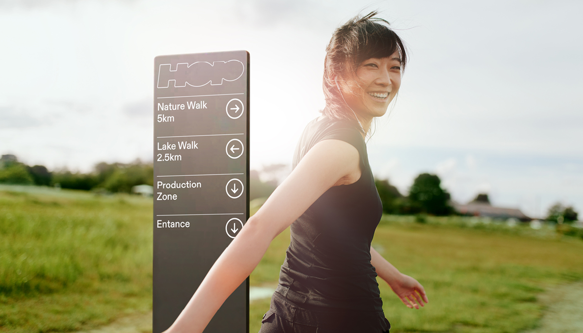Woman walking past sign