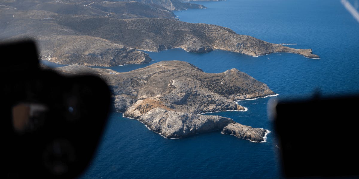 Aerial view of Aegean islands from above: Private helicopter charter over the Cyclades