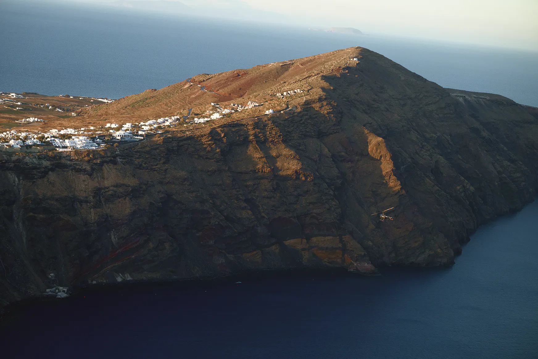 What's the best thing to do in Santorini? - hoper helicopter flying over the Santorini waters