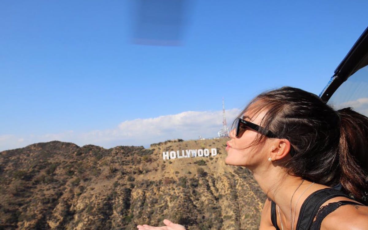Passengers Inside the helicopter with the Hollywood sign in the Background