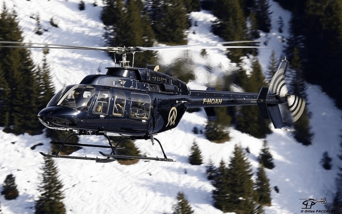 Helicopter flying above snowy mountains