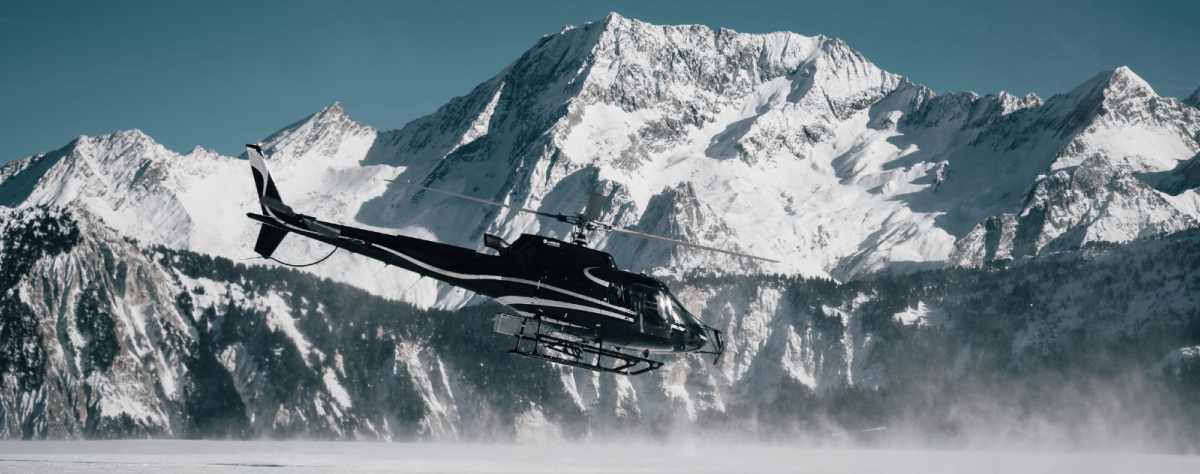 Helicopter taking off with background the Alps