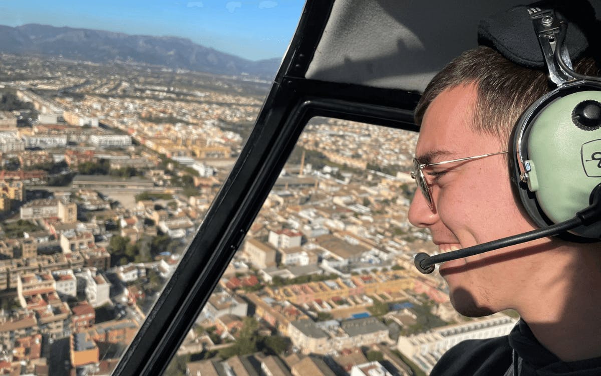 A man starring at the city of Mallorca from a helicopter