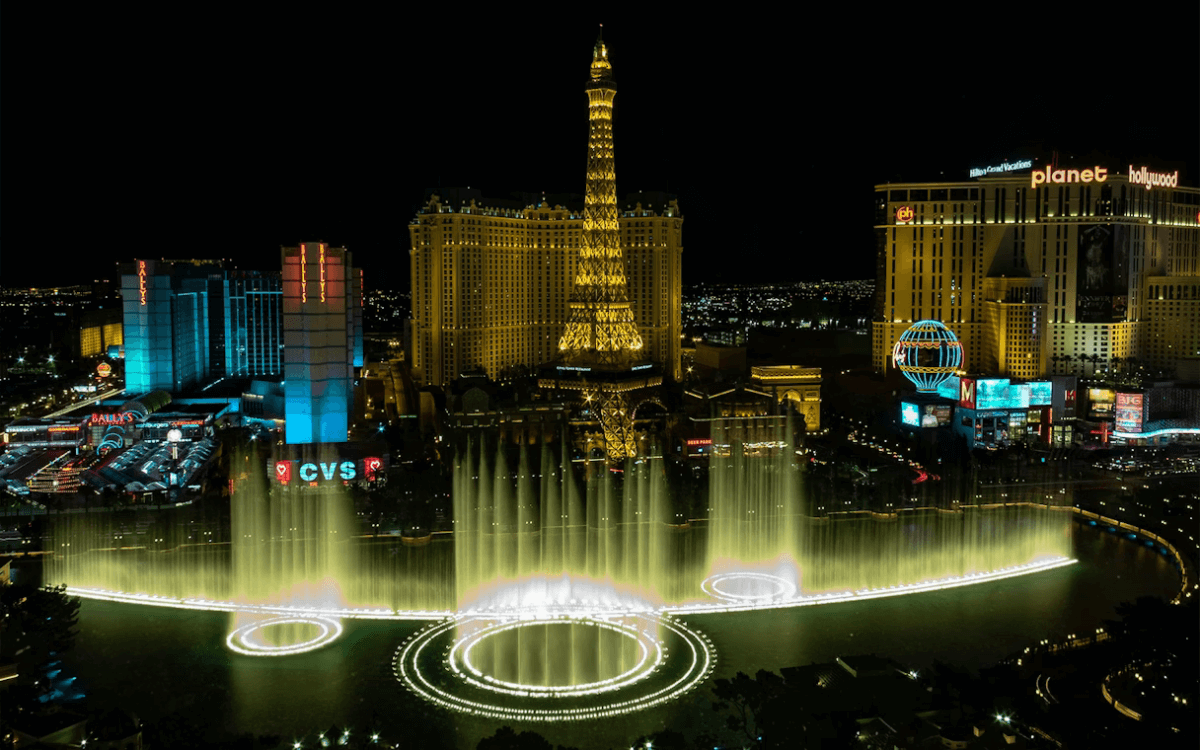Bellagio fountains with the Eiffel Tower behind, view from helicopter at night