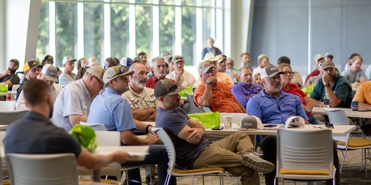 Attendees listen to speakers at the Field Day.