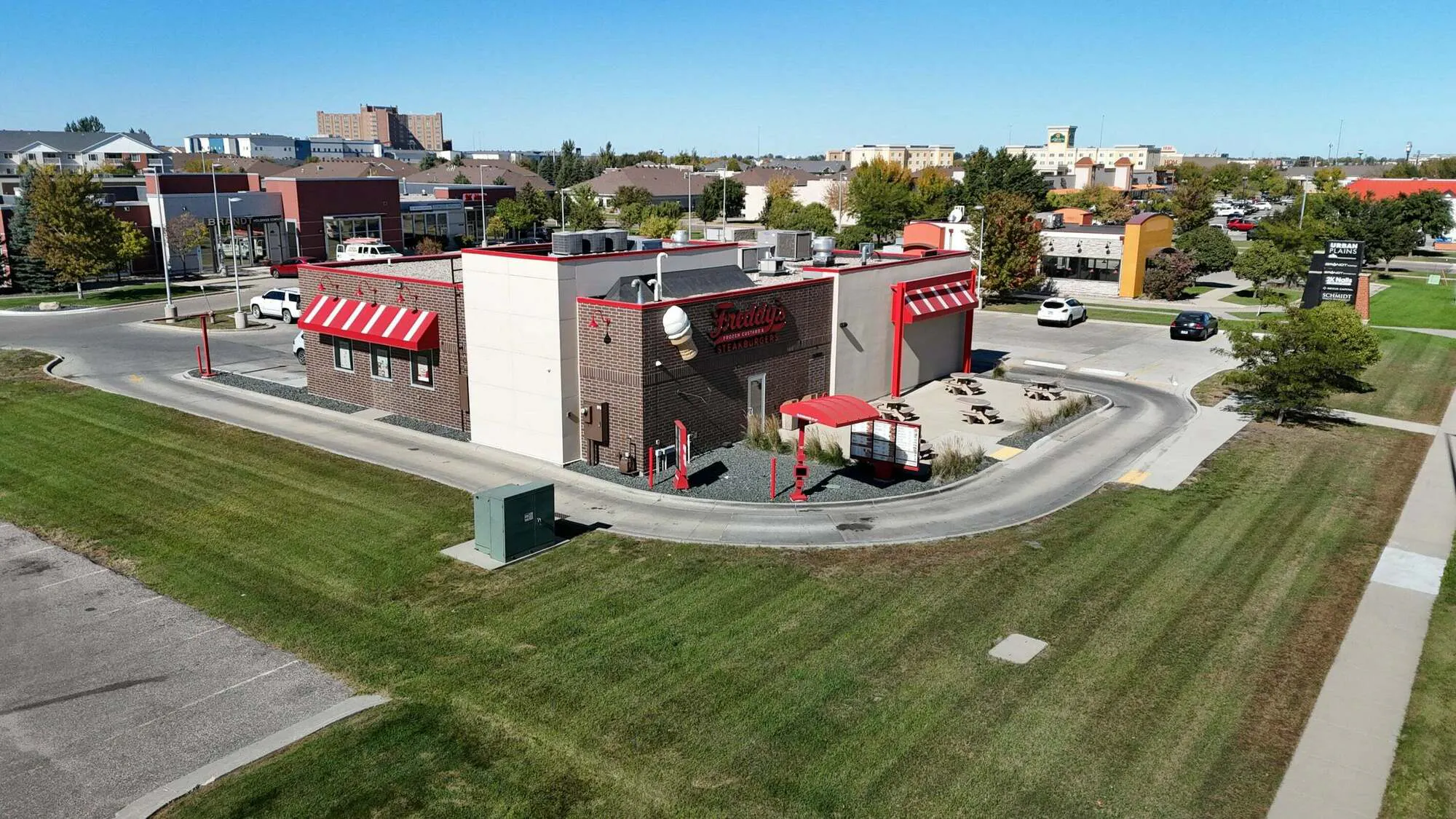 Freddy's Fargo building with drive-thru lane and outdoor patio seating along 45th Street South