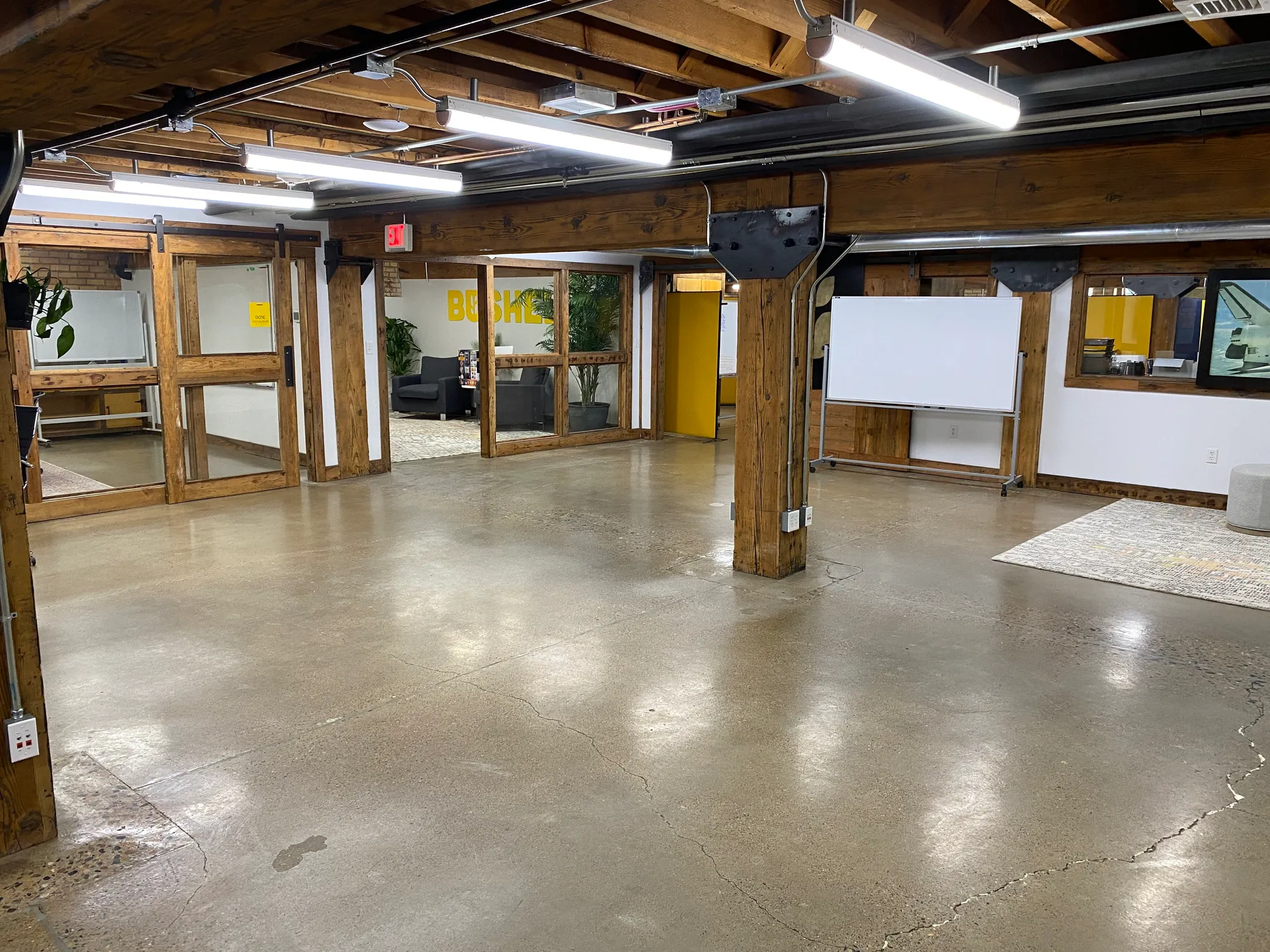 Open office space with timber columns and polished concrete floors in the Meadowlark Building