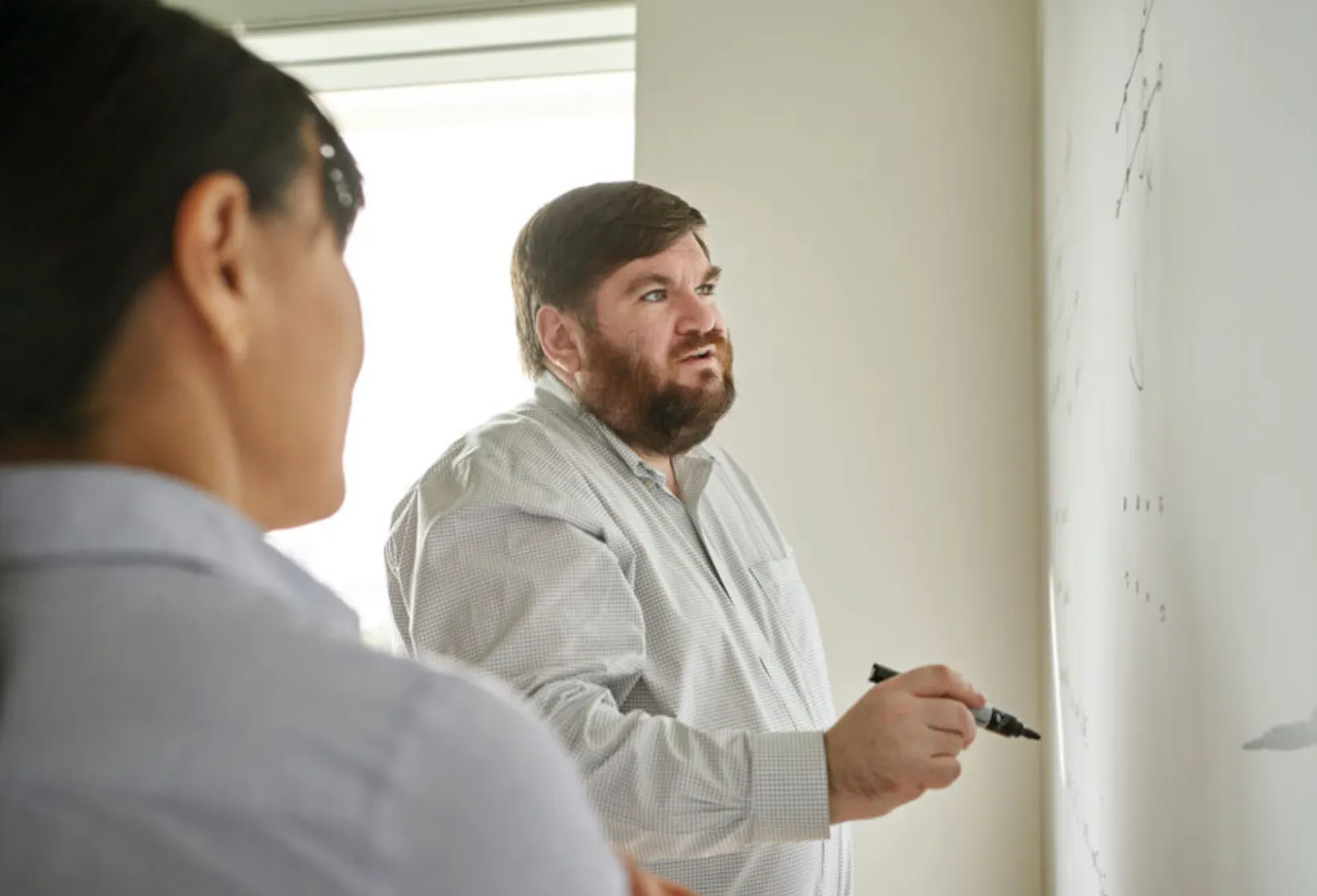 Dr. Joe Fitzsimons working at a whiteboard