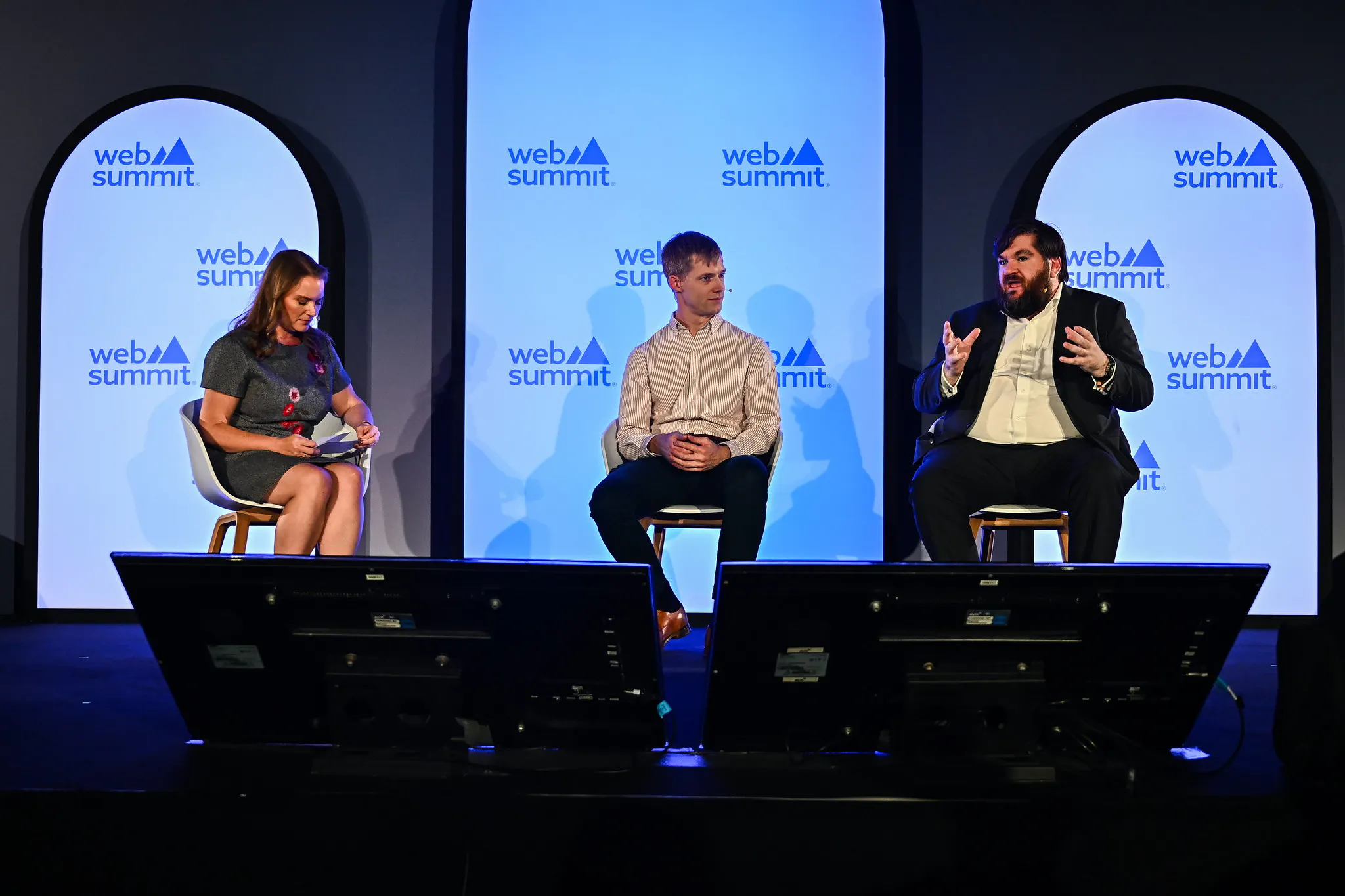 Dr Joe Fitzsimons on stage alongside two other panelists