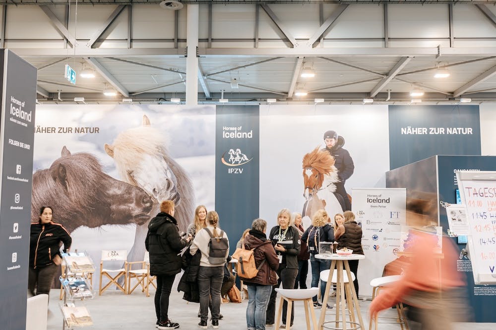 People talking to Berglind Margo Þorvaldsdóttir at Horses of Iceland's stand at Equitana