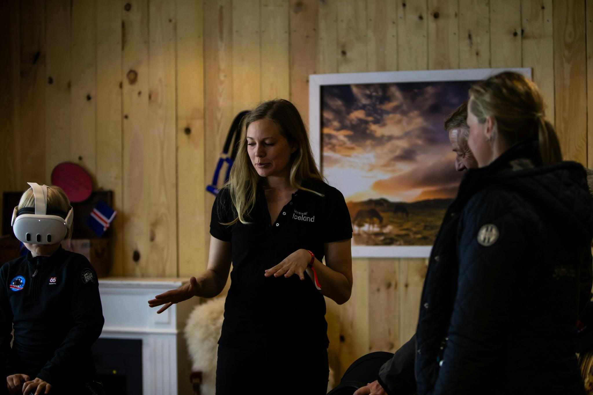 Berglind Margo Þorvaldsdóttir, head of Horses of Iceland, explains how the project works to a woman while her child is on a virtual ride through VR glasses.