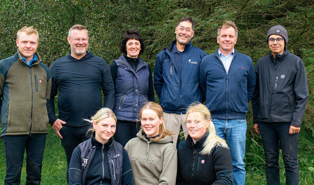 The researchers behind the study about the recovery time of Icelandic horses after a pace race pose for a photo with students and a rider for a group photo.