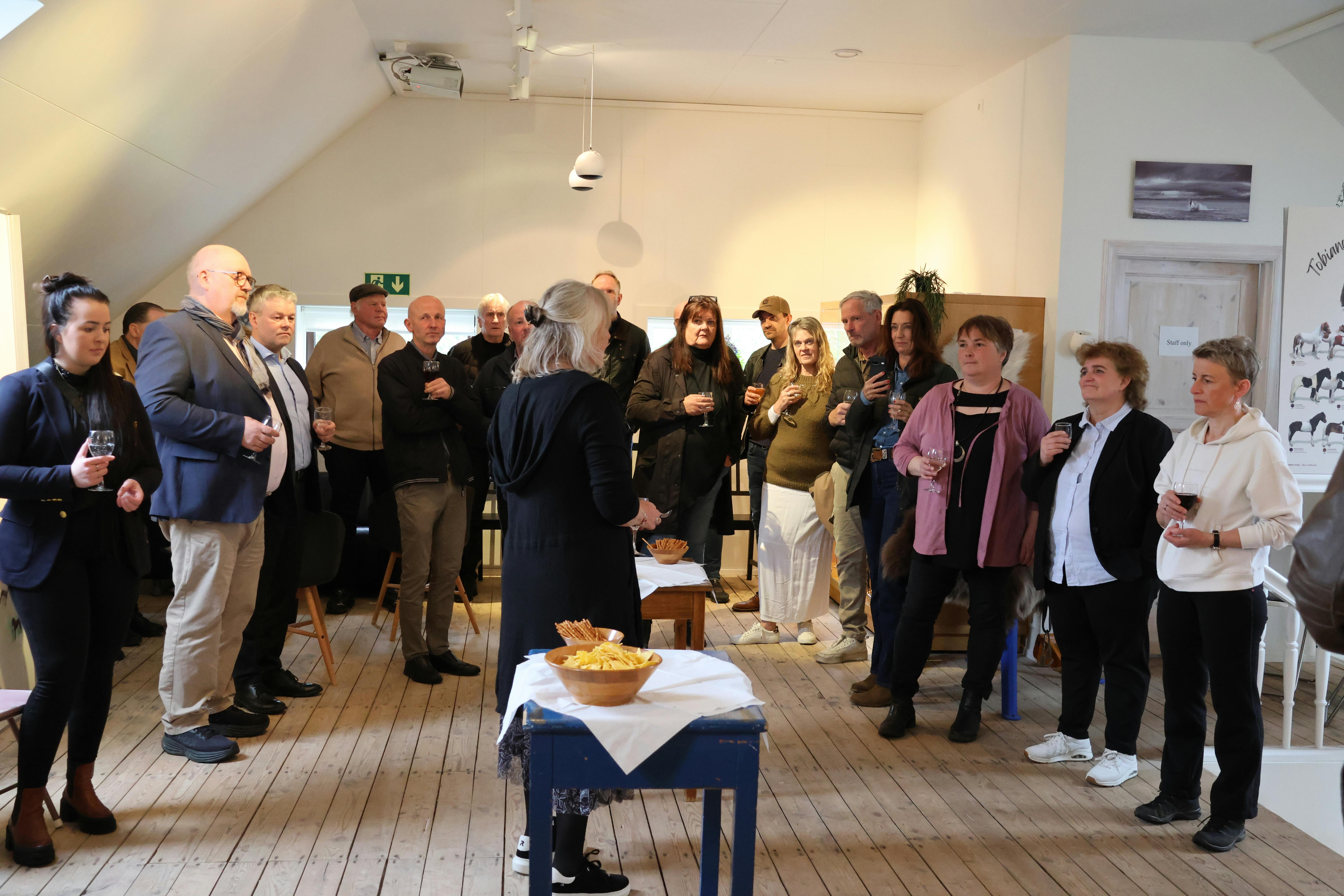 Guests listen to Kristín Halldórsdóttir as she gives a speech at the 2025 opening of the Icelandic Horse History Center.