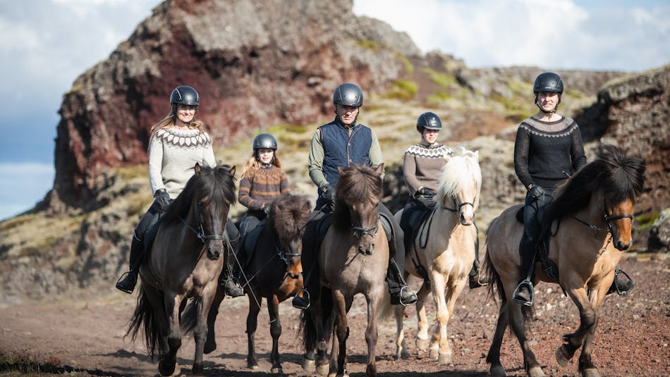 Five riders of various ages ride Icelandic horses in Rauðhólar, Iceland