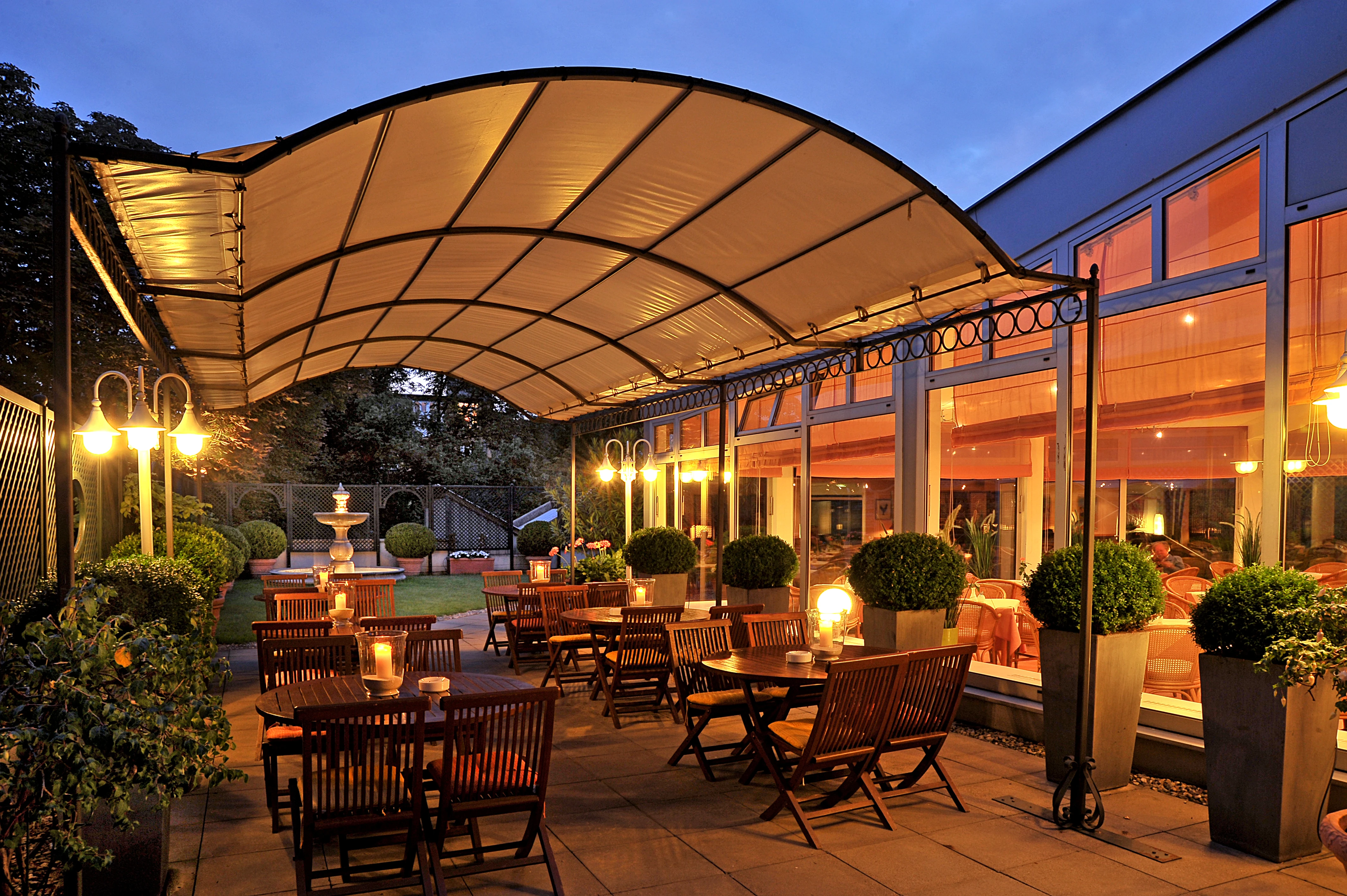 View of the hotel terrace with candles on the tables giving a warm feel.