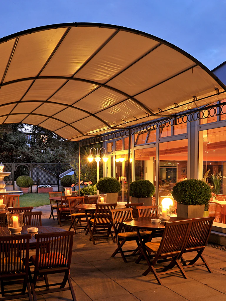 View of the hotel terrace with candles on the tables giving a warm feel.