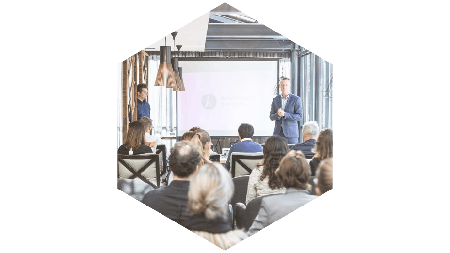 Hotelier.com masterclass showing two presenters and audience