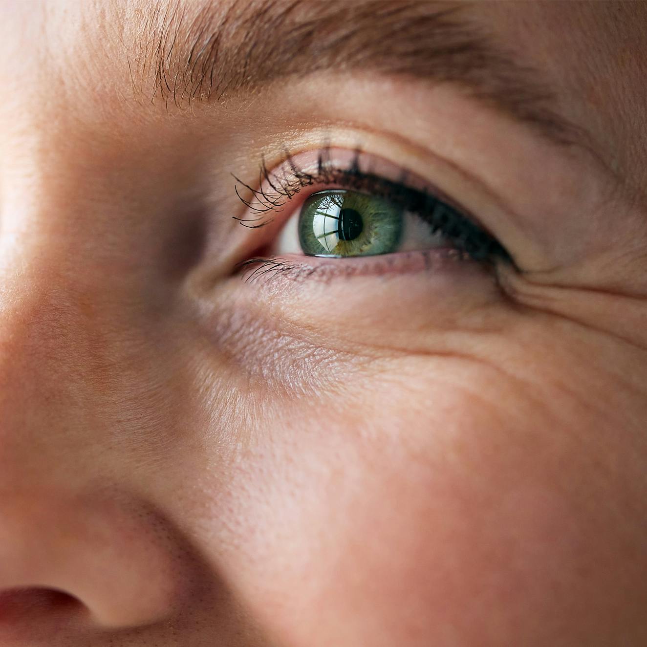 A woman with crow's feet lines and wrinkles