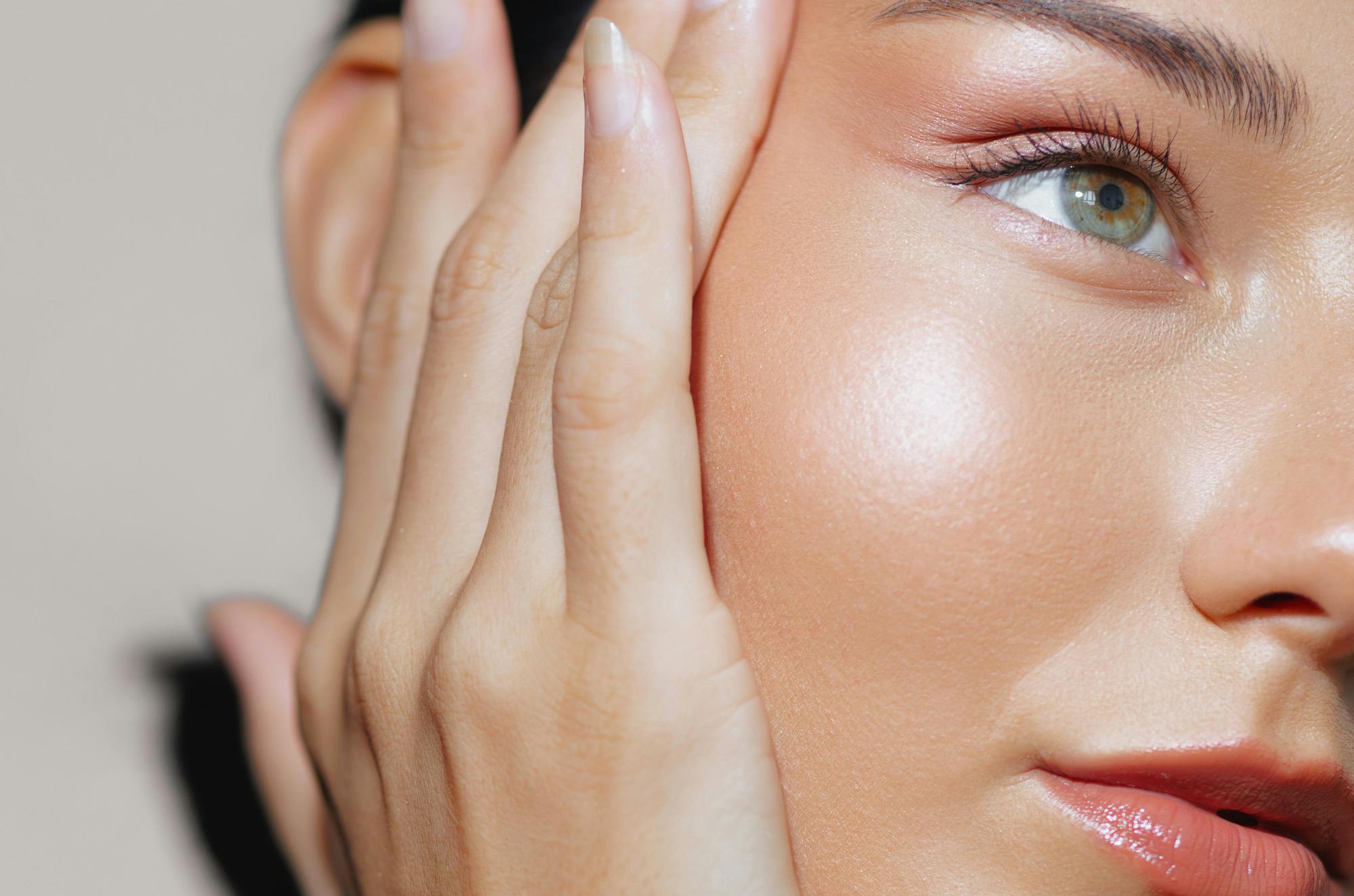 A woman with glowing skin following treatments and facials