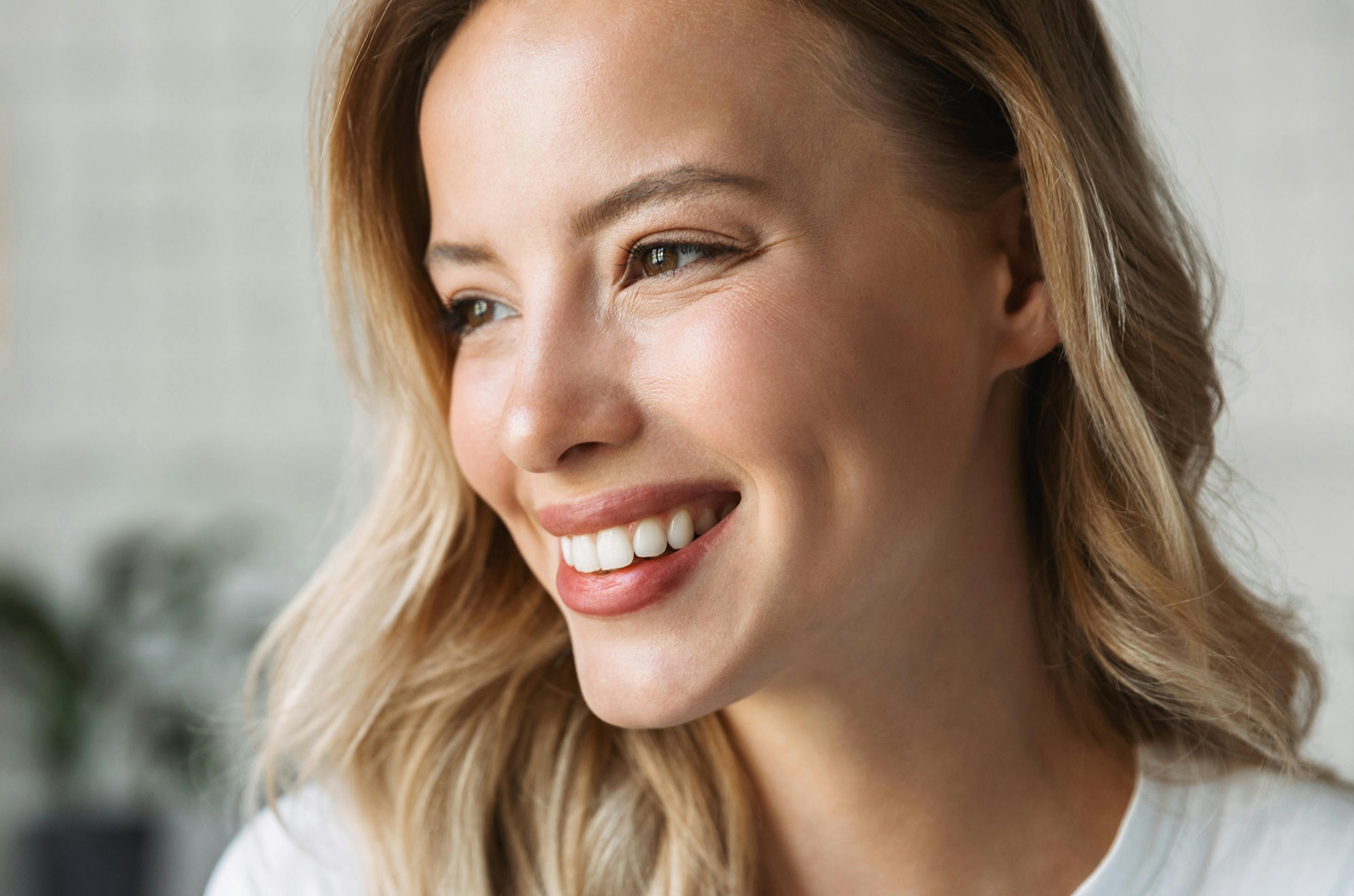 A smiling woman following wellness treatments