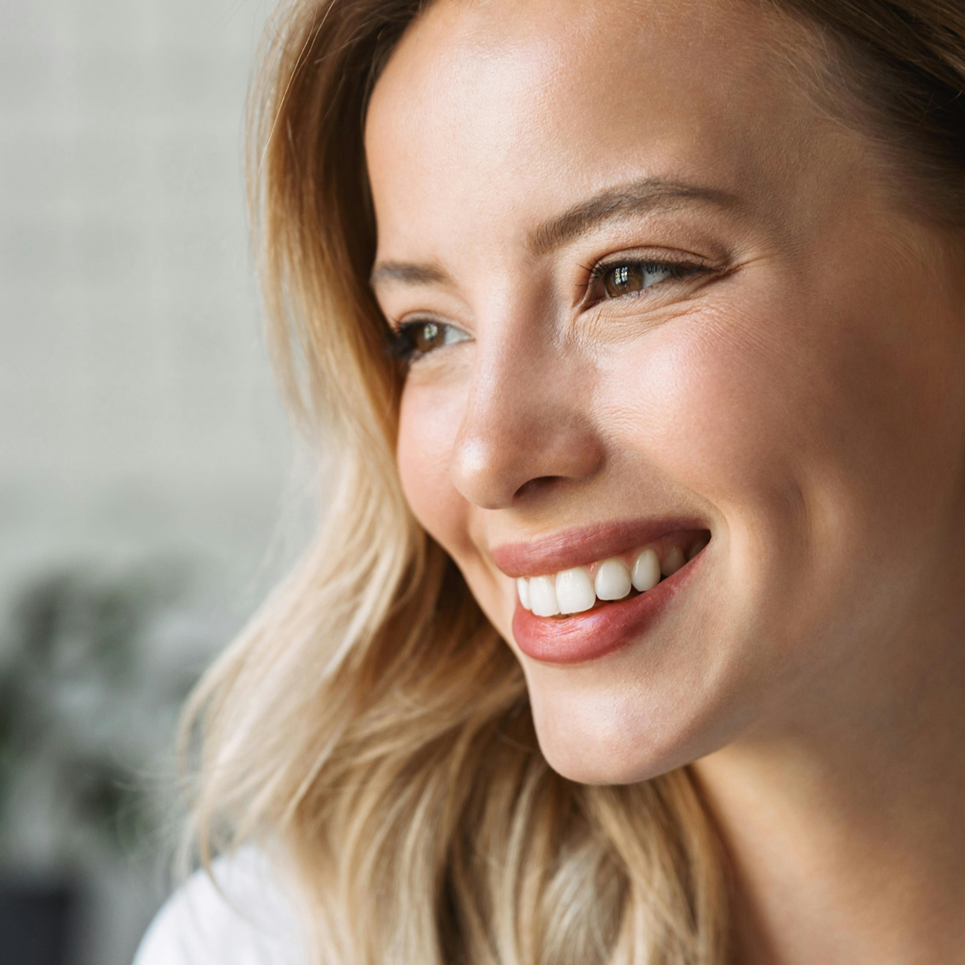 A smiling woman following her wellness treatments