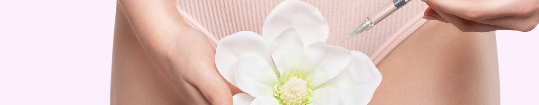 Woman holding white flower denoting female intimate rejuvenation treatments