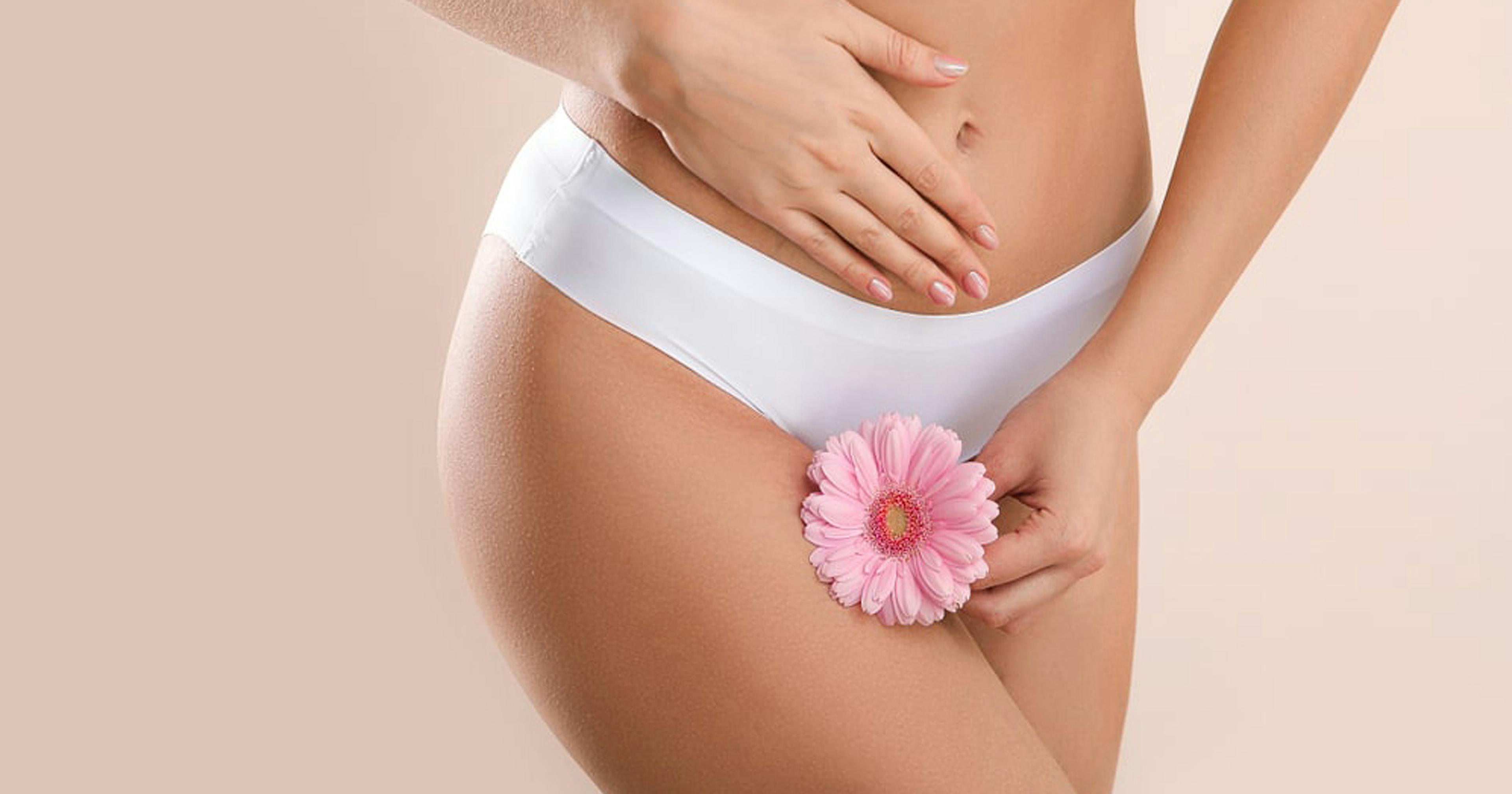 Vaginal rejuvenation image - woman holding pink flower