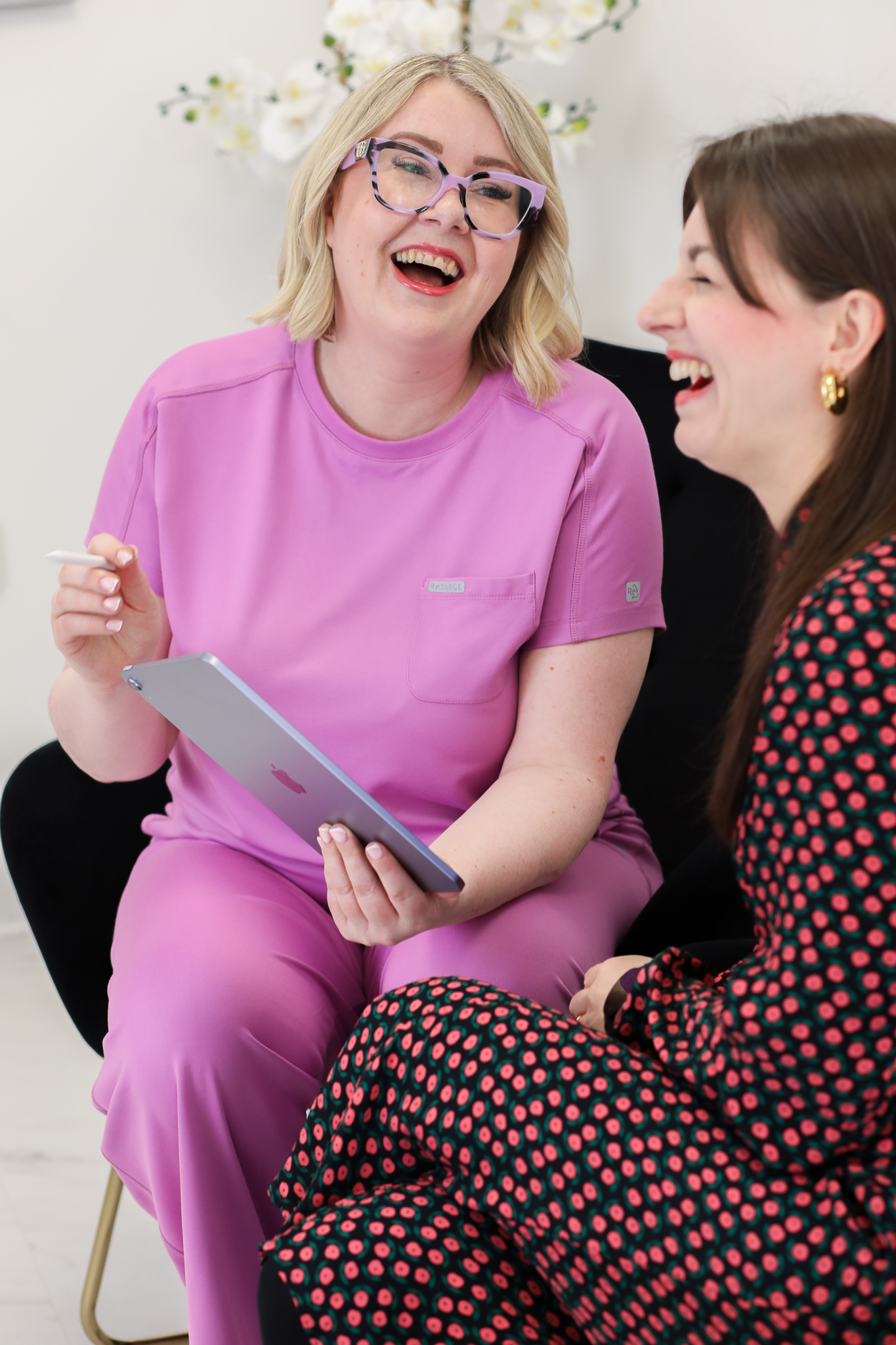 House of Glo owner Julie and a patient laughing together