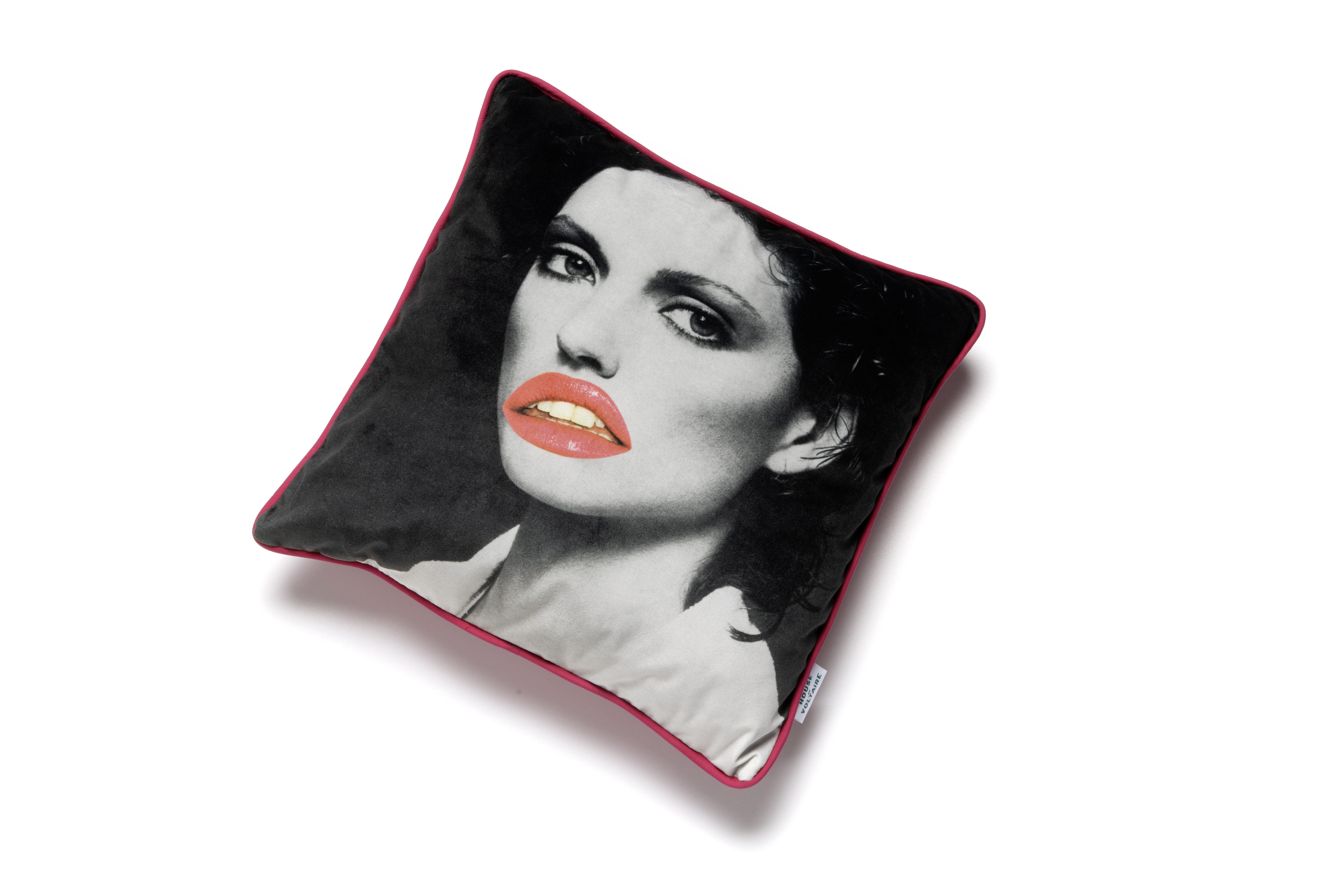 A square pillow with a black and white portrait of a person. The lips are coloured in bright orange-red, contrasting with the monochrome image. The pillow has a thin red border.