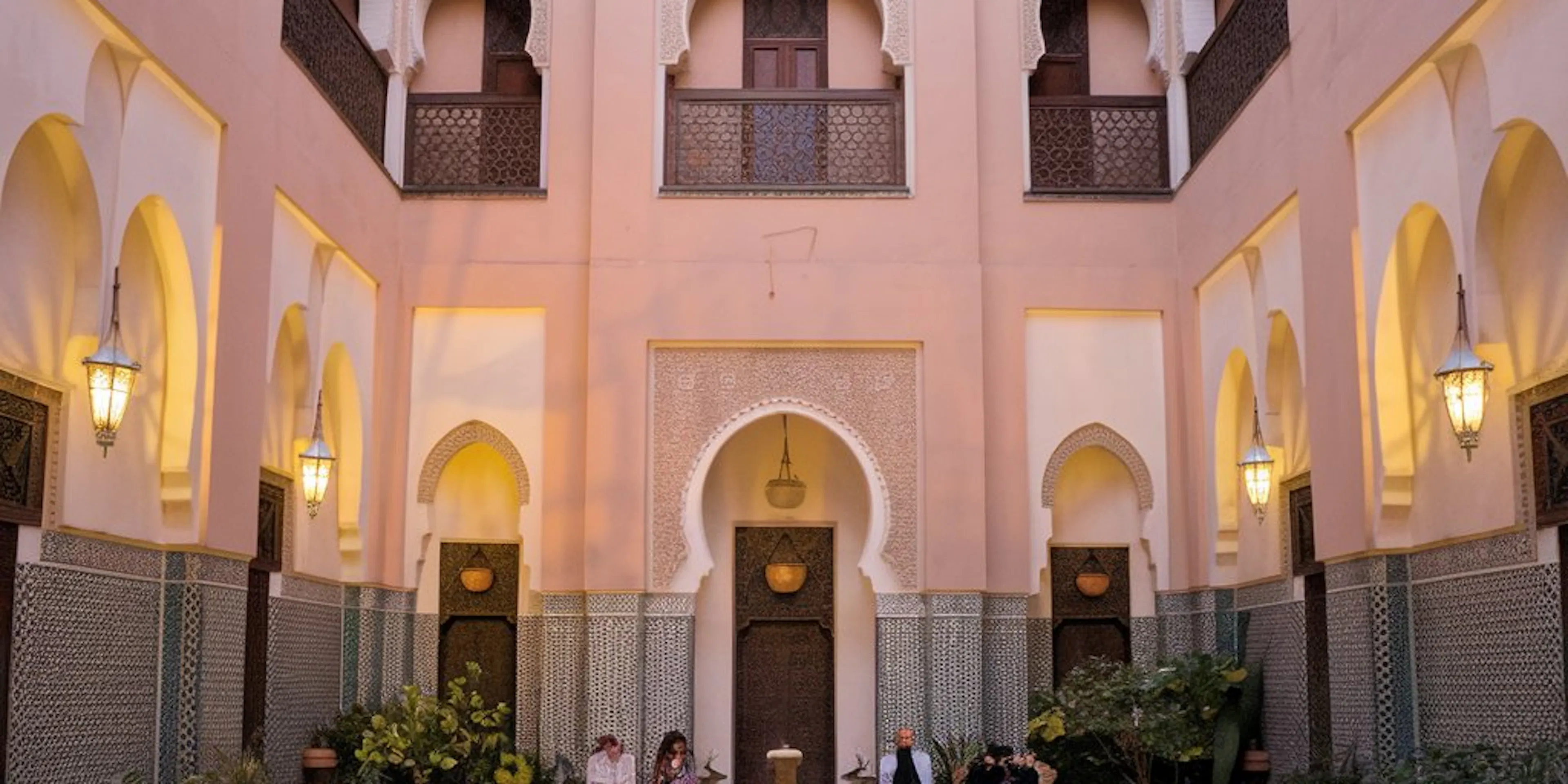 A pretty riad with people sitting in the front window