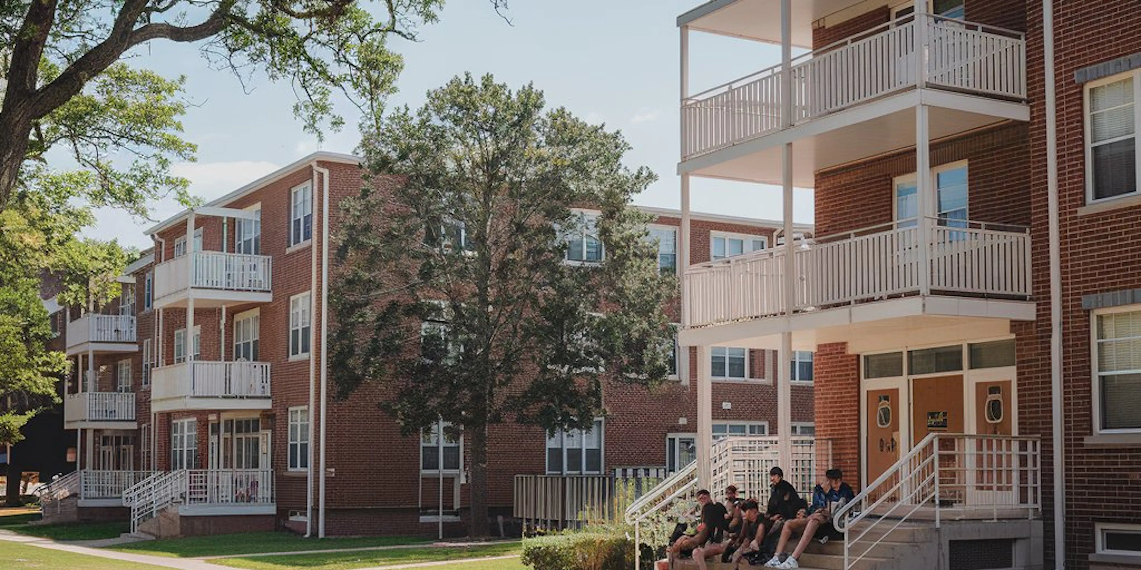 Young people in front of their building