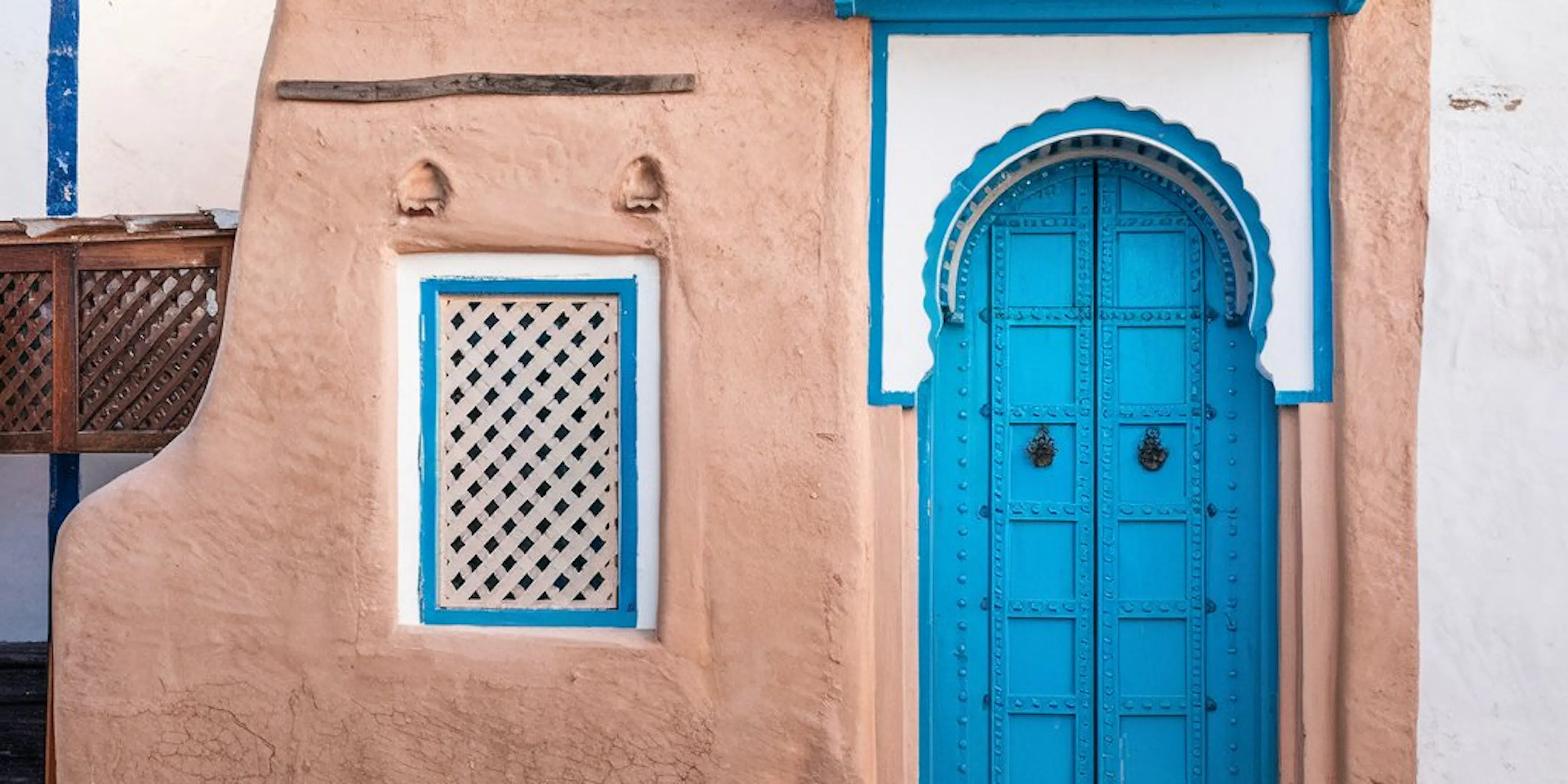 Une petite maison avec une porte bleu