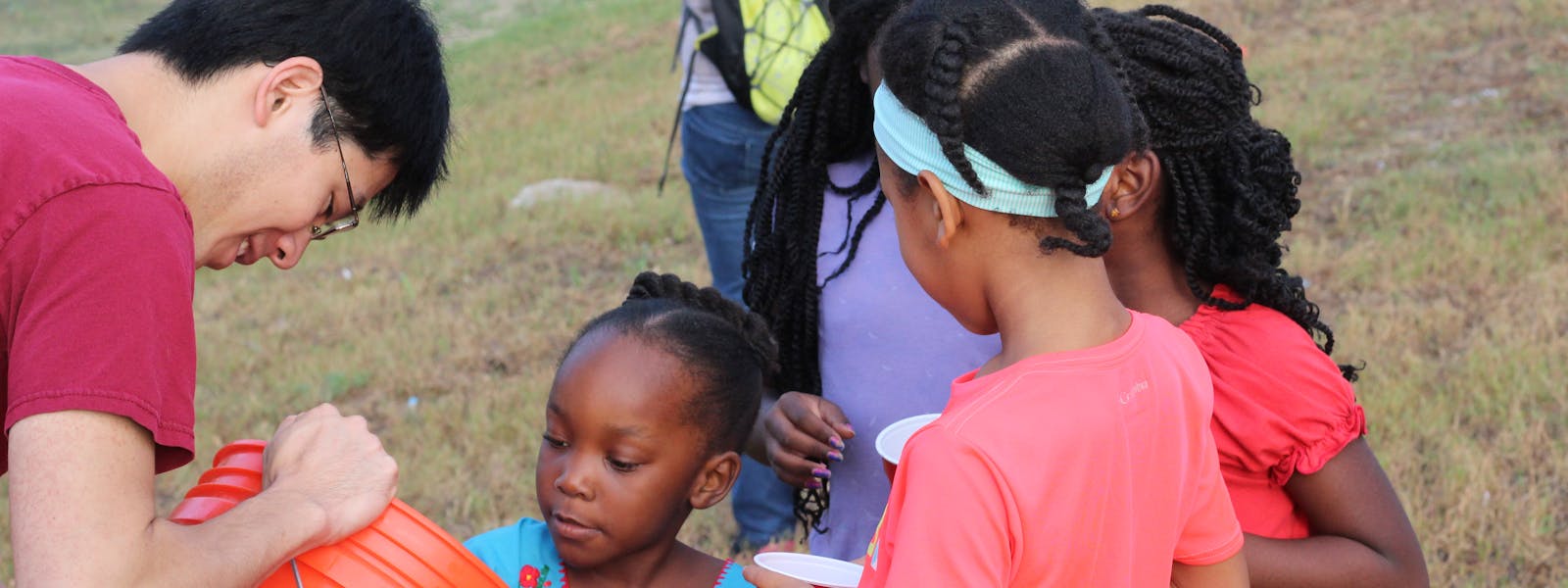 Volunteers and kids spreading wildflowers in Houston Parks