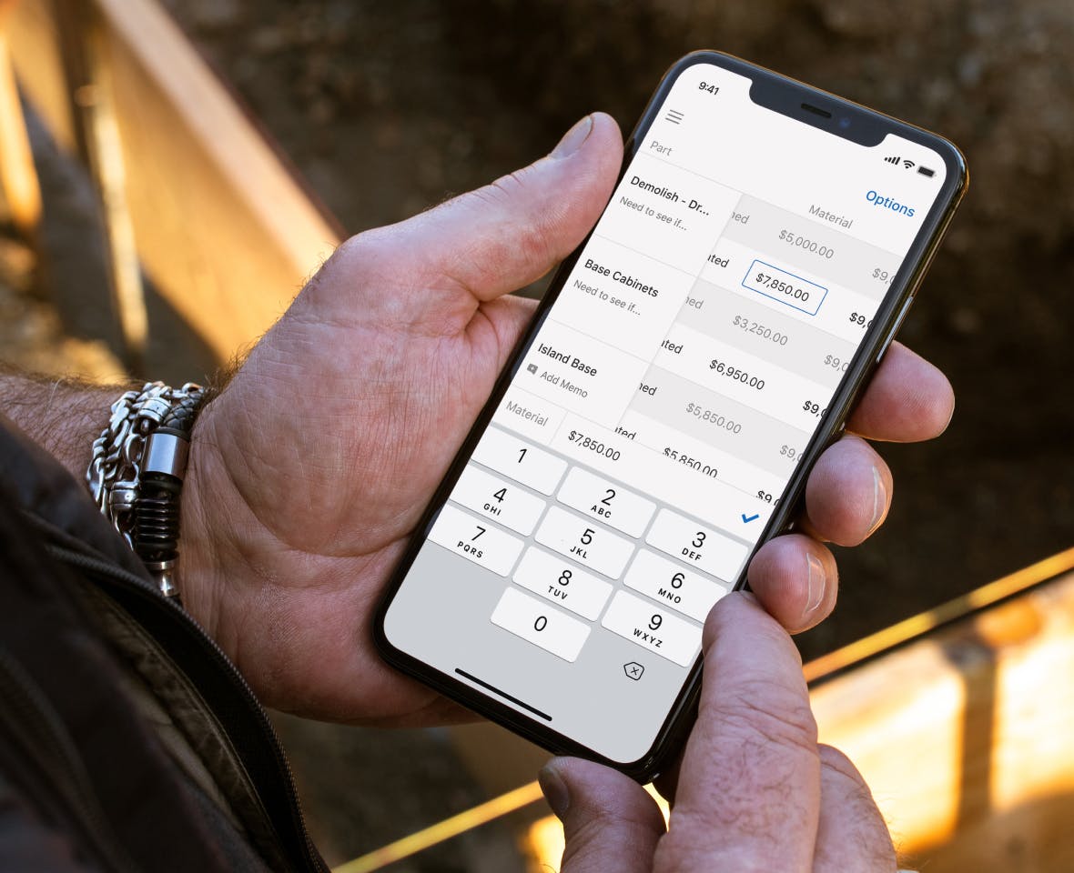 General contractor looks down at project management app