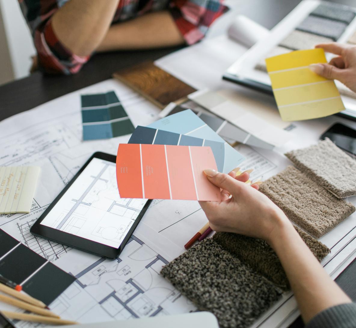 interior designer shows client paint swatches and color options 