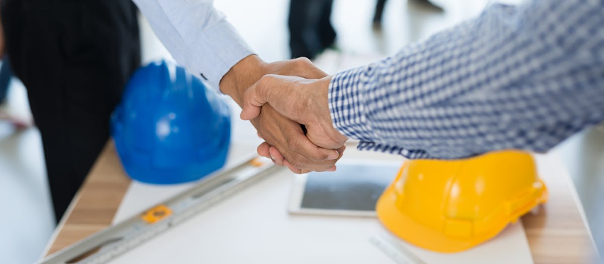 A newly hired pro shakes hands with their new client.