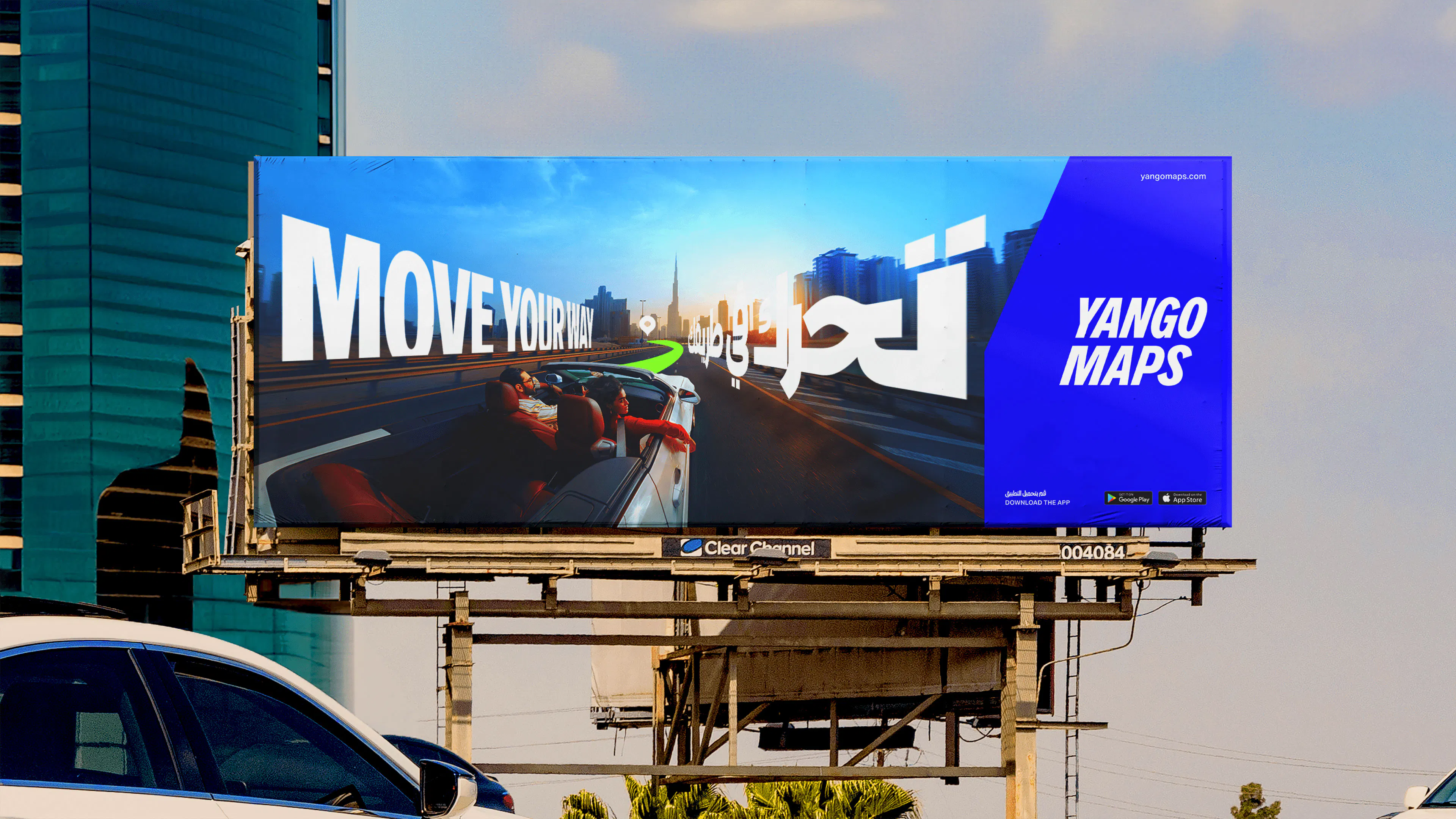 Yango Maps 'Move your way' billboard in English and Arabic beside a Dubai highway, showing a first-person road view