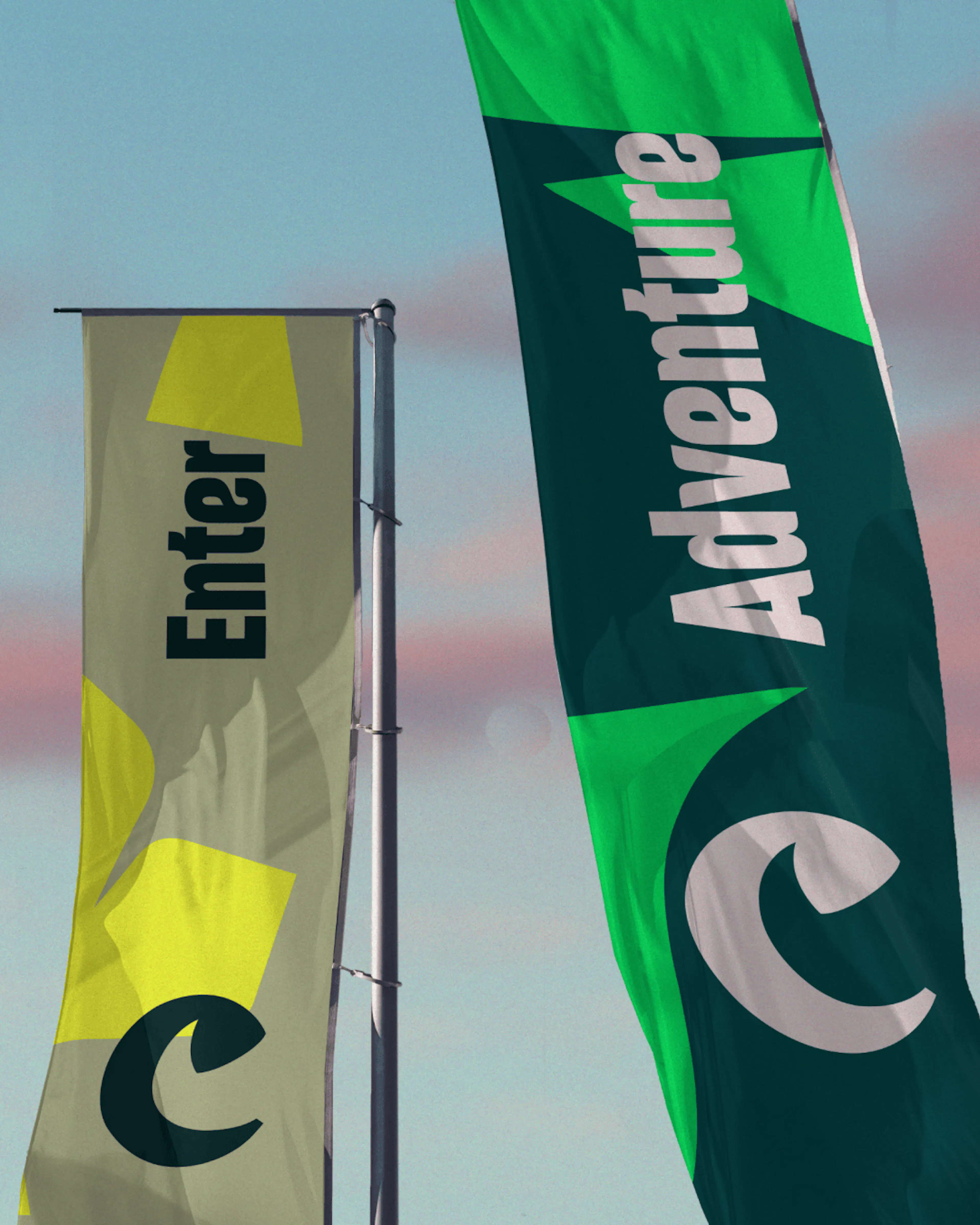 Chester Zoo flags reading 'Enter' and 'Adventure' against the sky