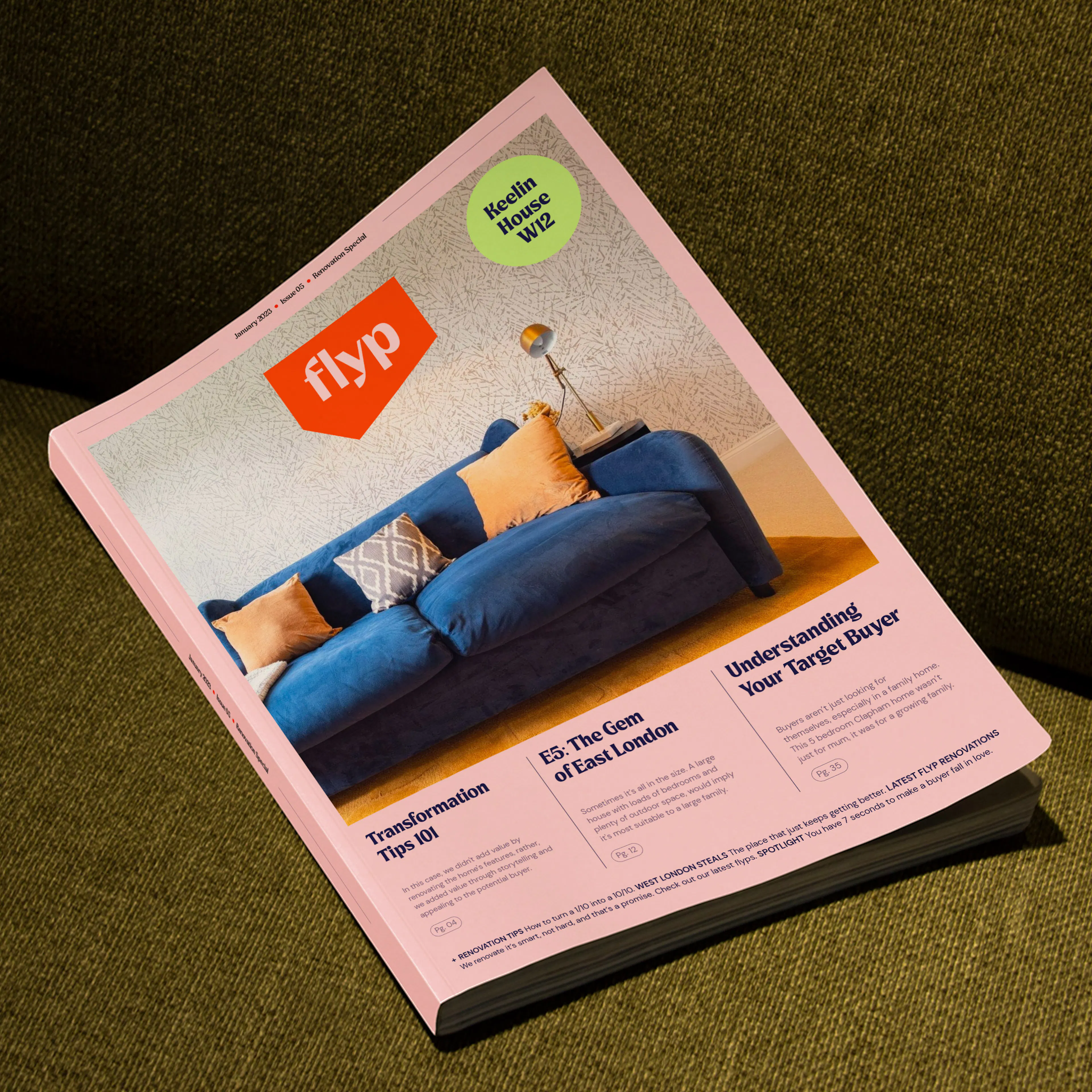 flyp magazine with a blue sofa on its pink cover, lying on a green sofa