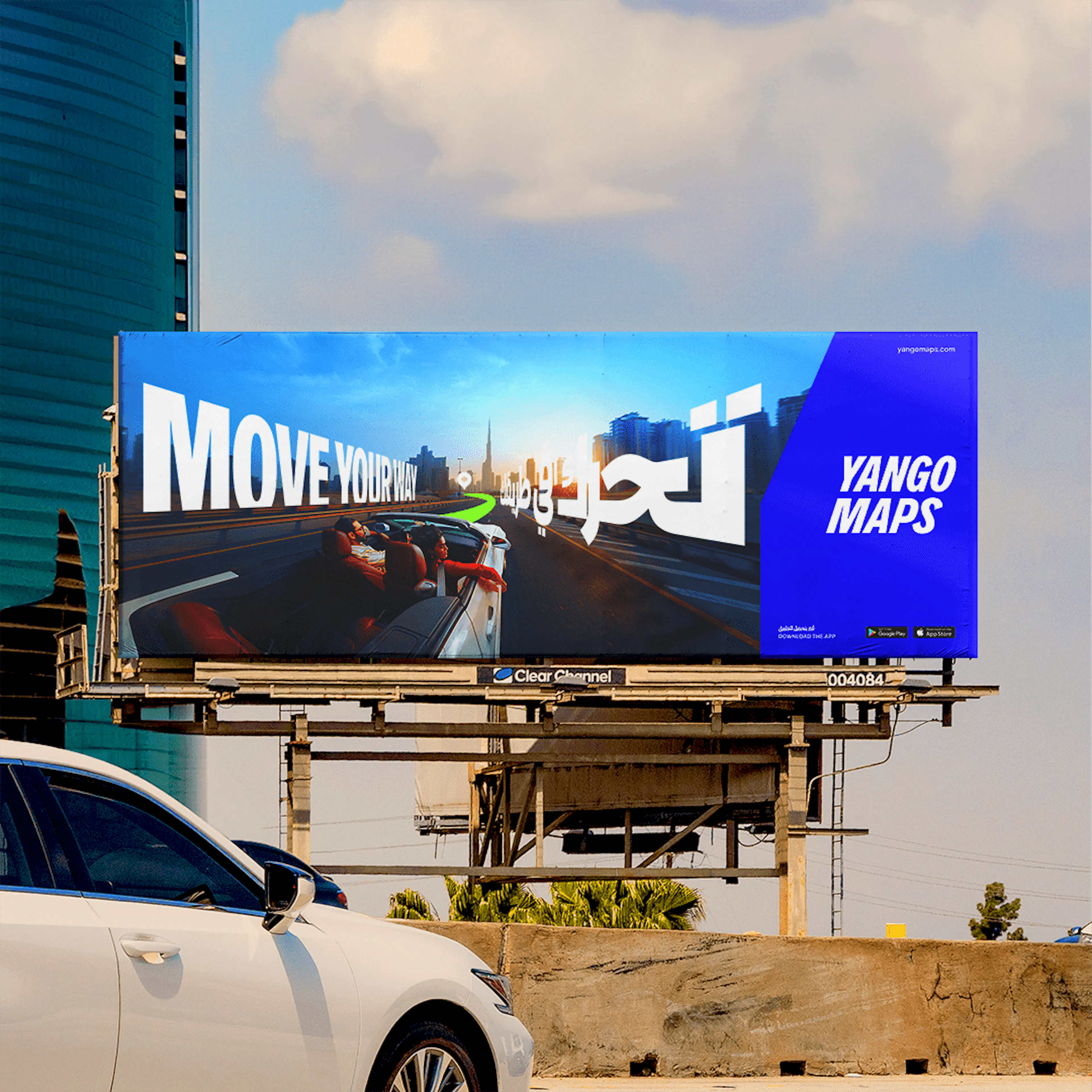 Yango Maps 'Move your way' billboard in English and Arabic beside a Dubai highway, showing a first-person road view