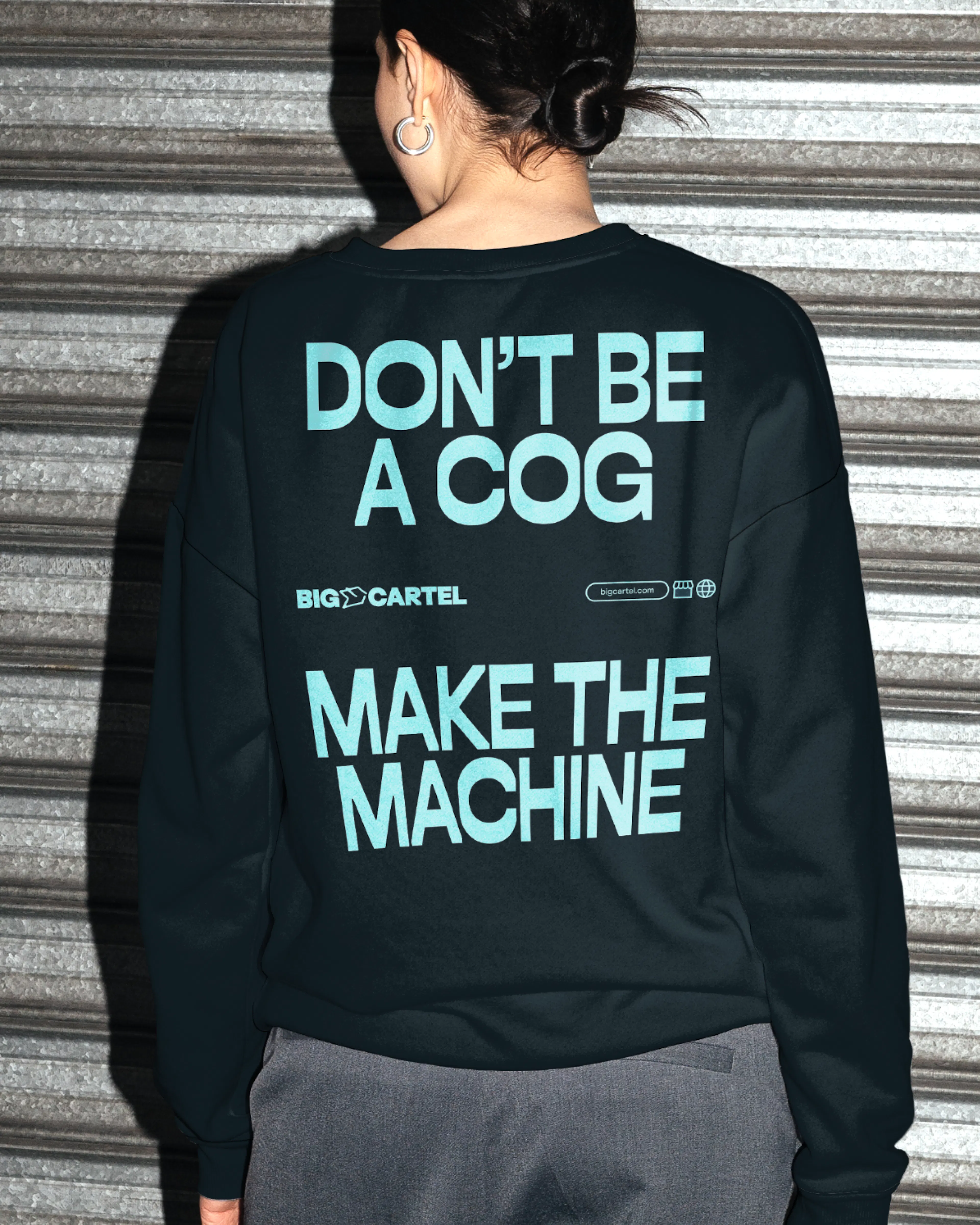 Back of a sweatshirt reading 'Don't be a cog, make the machine'