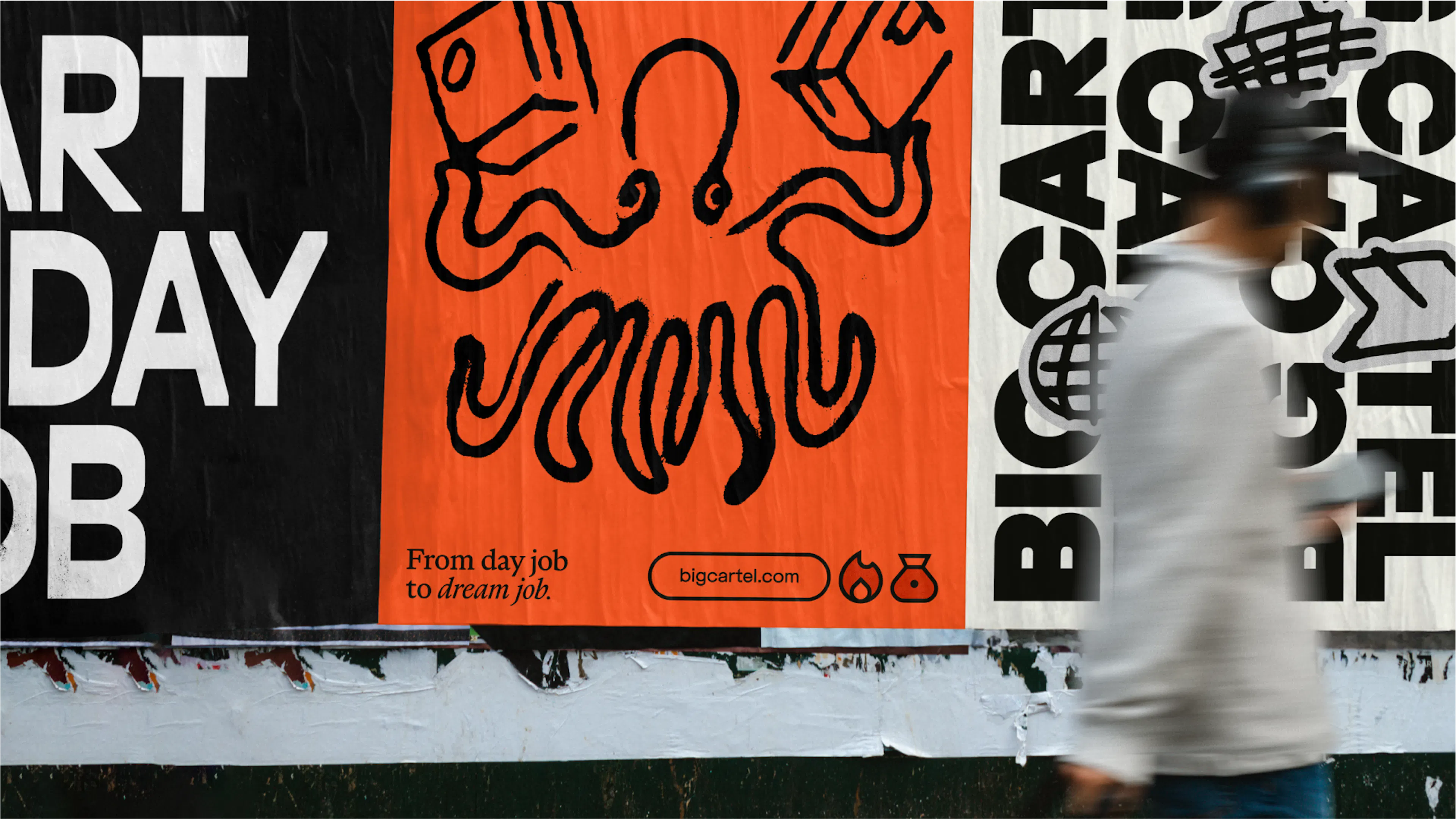 Person walking past Big Cartel street posters, including an orange octopus illustration