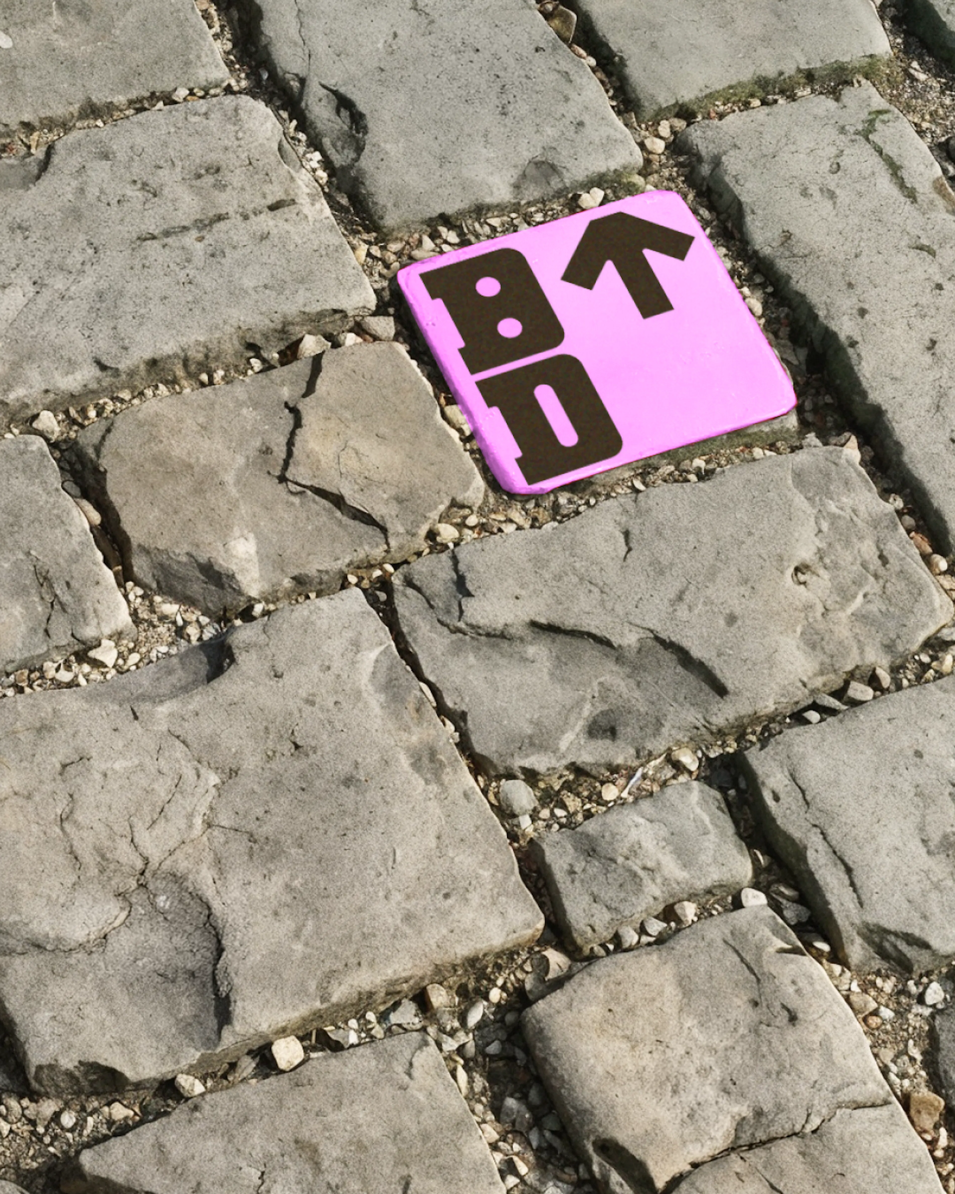 Cobble stone with BD for Bristol Dockyards on one of them in pink